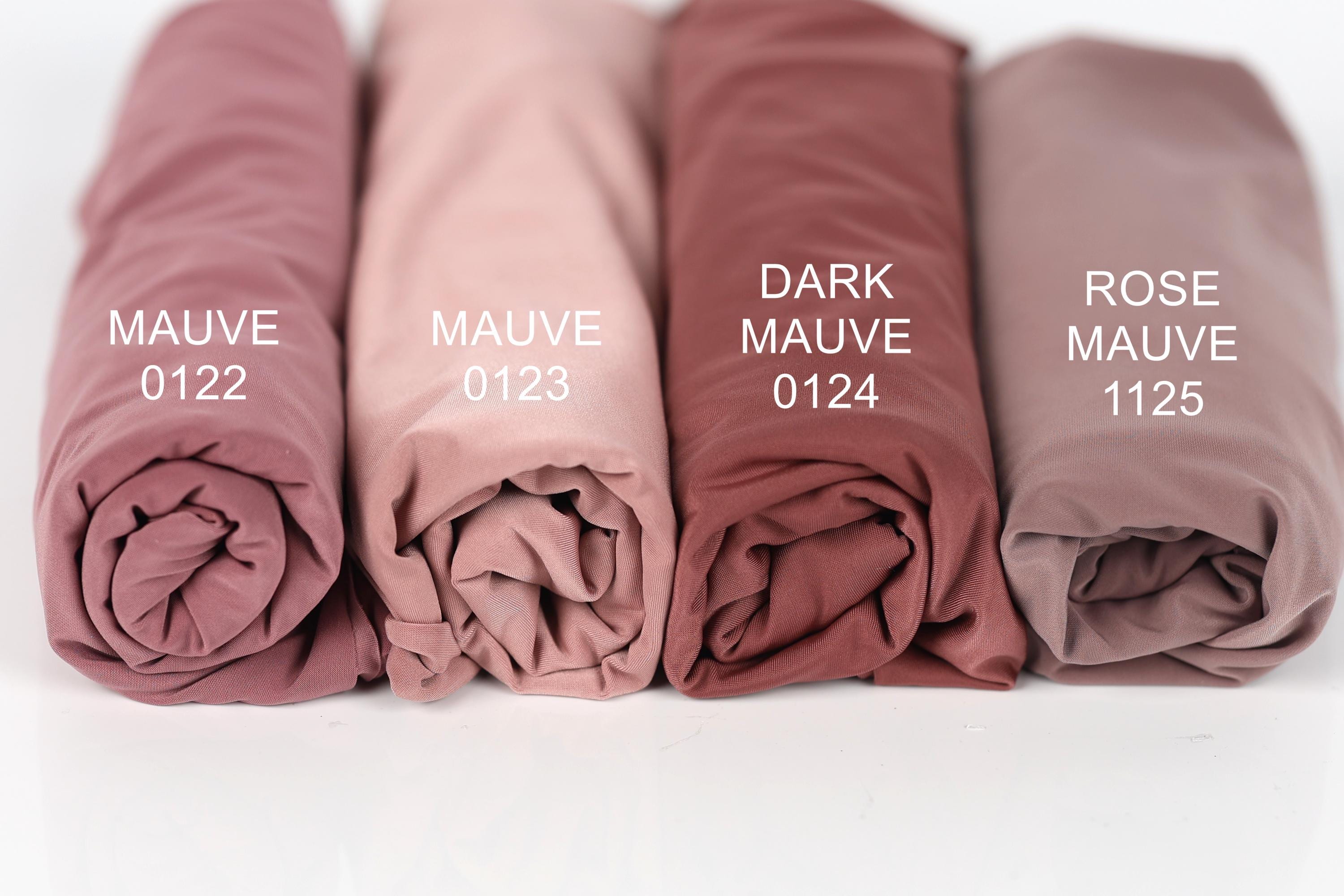 Four rolled-up fabric swatches in different shades of pink, labeled with the names "MAUVE 0122", "MAUVE 0123", "MAUVE 0124", and "MAUVE 1125".