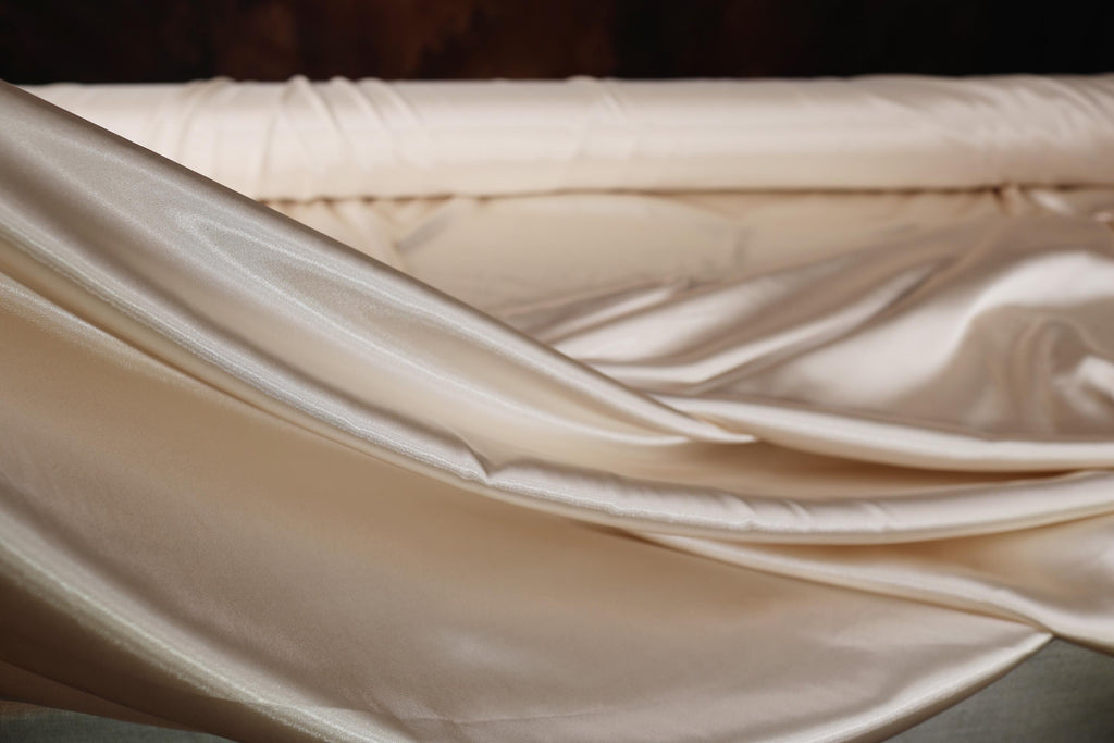 a close up of a bed with a sheet on it