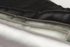 A close-up image of a collection of fabric swatches in various shades of black, gray, and white.