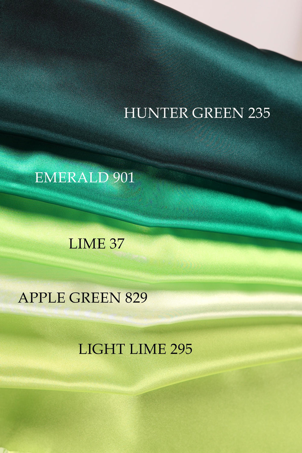 a collection of fabric swatches in various shades of green, including emerald, lime, apple, and light lime.