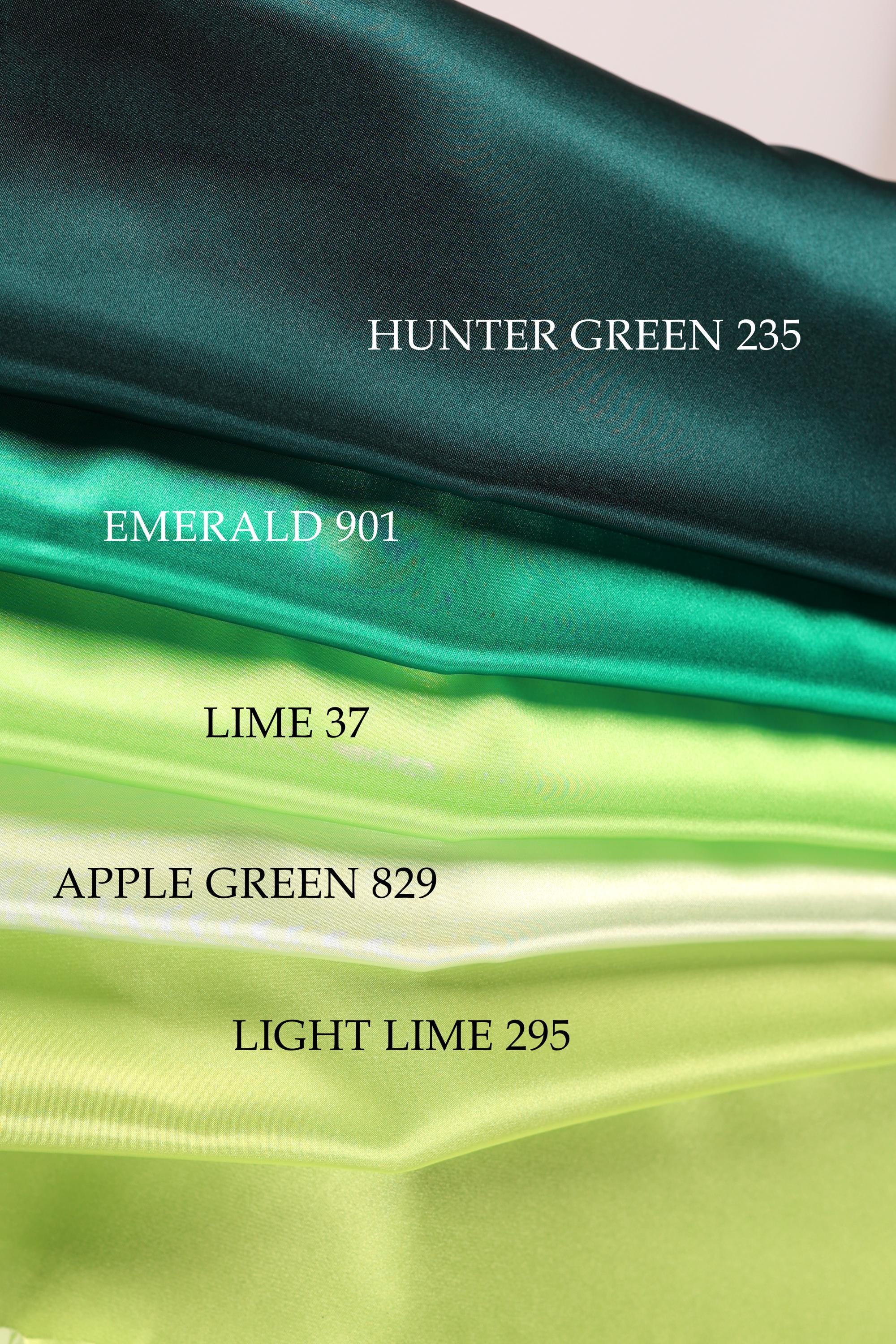 a collection of fabric swatches in various shades of green, including emerald, lime, apple, and light lime.