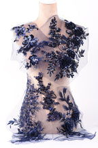 a dress with a floral pattern and sequin details, including blue flowers and sequins.