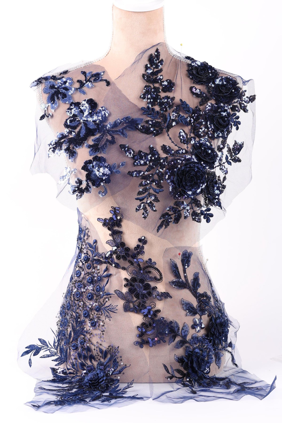 a dress with a floral pattern and sequin details, including blue flowers and sequins.
