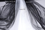a close-up view of a black and white fabric, possibly a sheer or sheer-like material, with a text overlay indicating the color and material of the fabric.