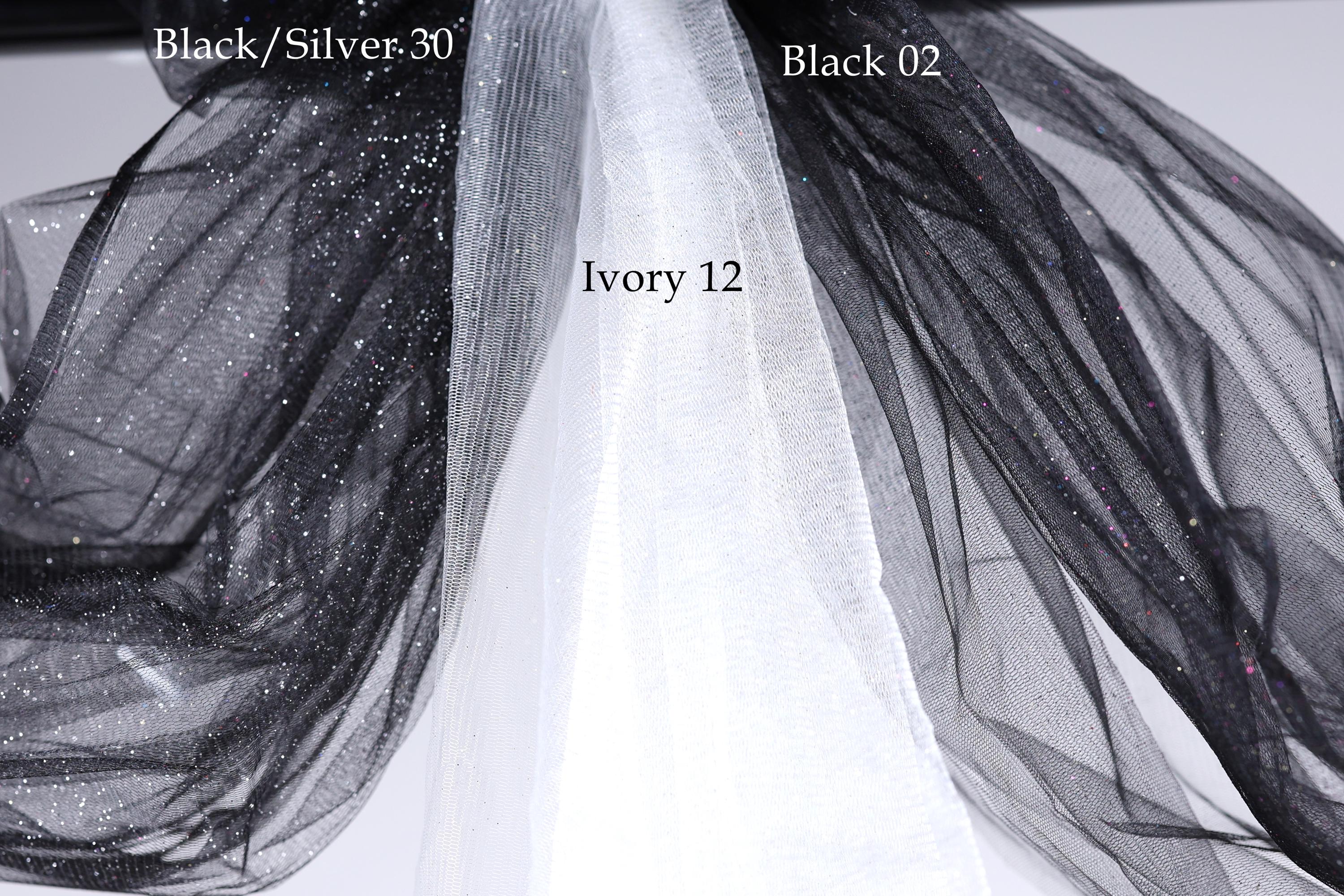 a close-up view of a black and white fabric, possibly a sheer or sheer-like material, with a text overlay indicating the color and material of the fabric.