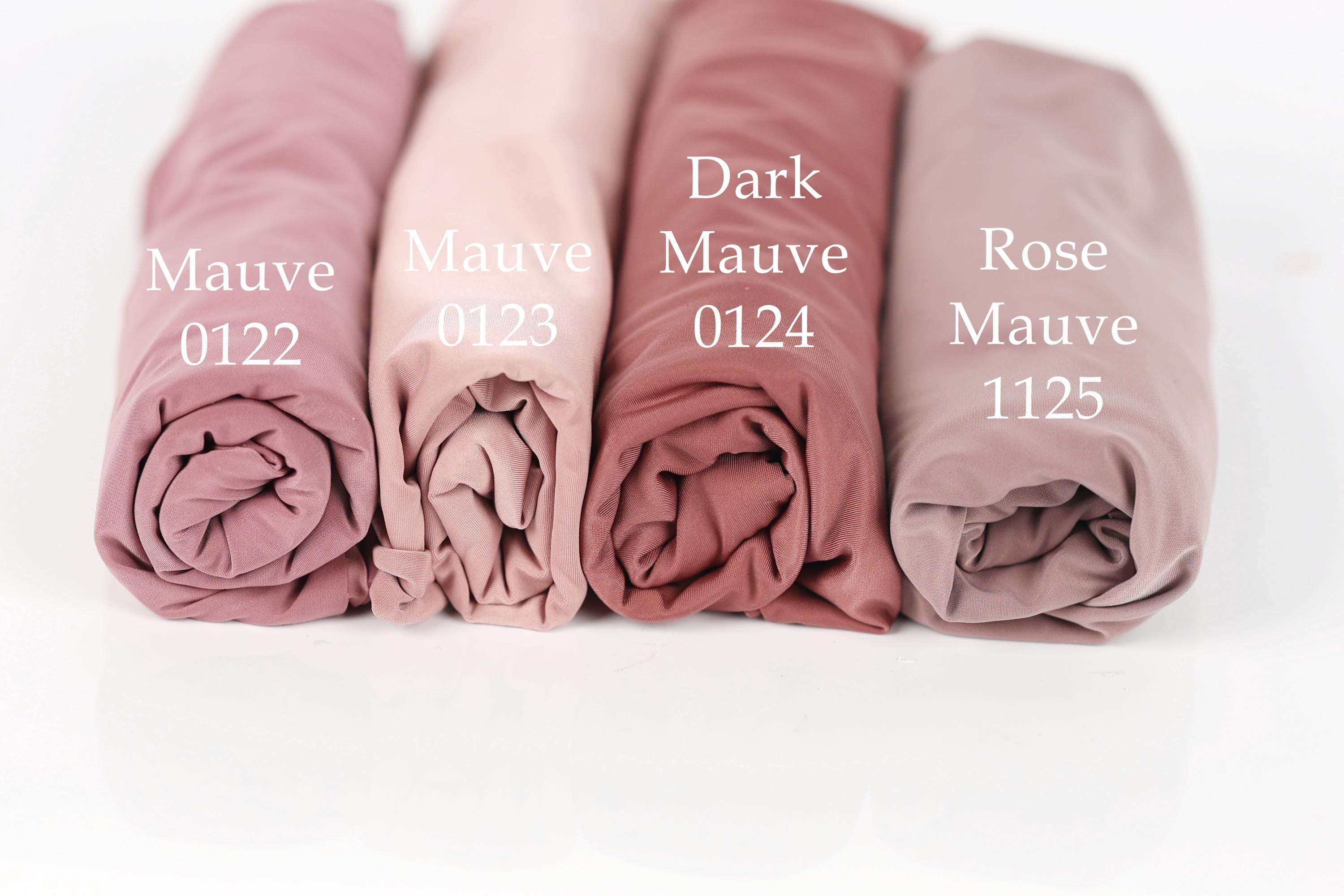 Four rolled-up fabric swatches in different shades of pink, labeled with the names of the colors: Mauve, Dark Mauve, Rose Mauve, and Mauve 0122.