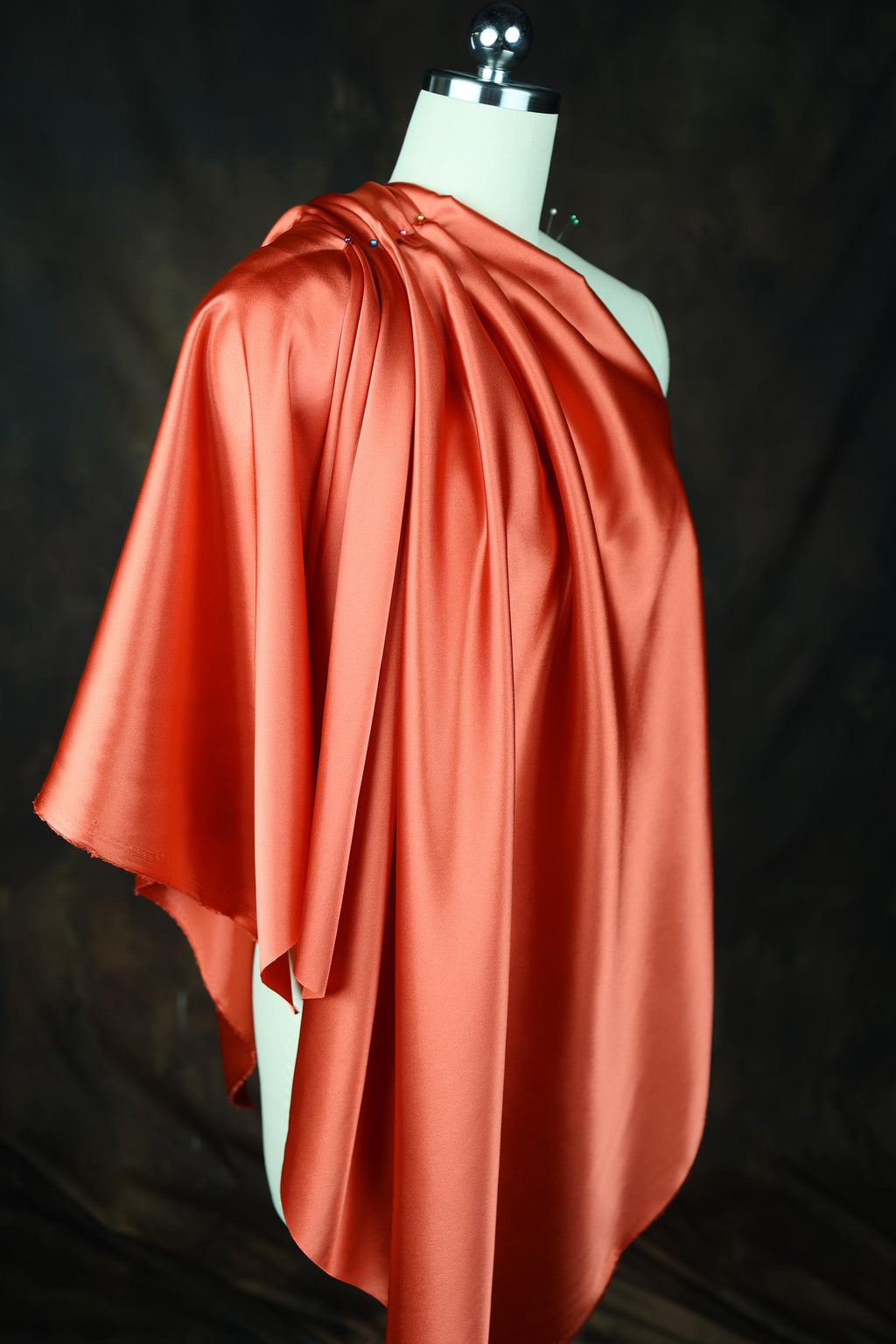 a dress on a mannequin wearing a red cape