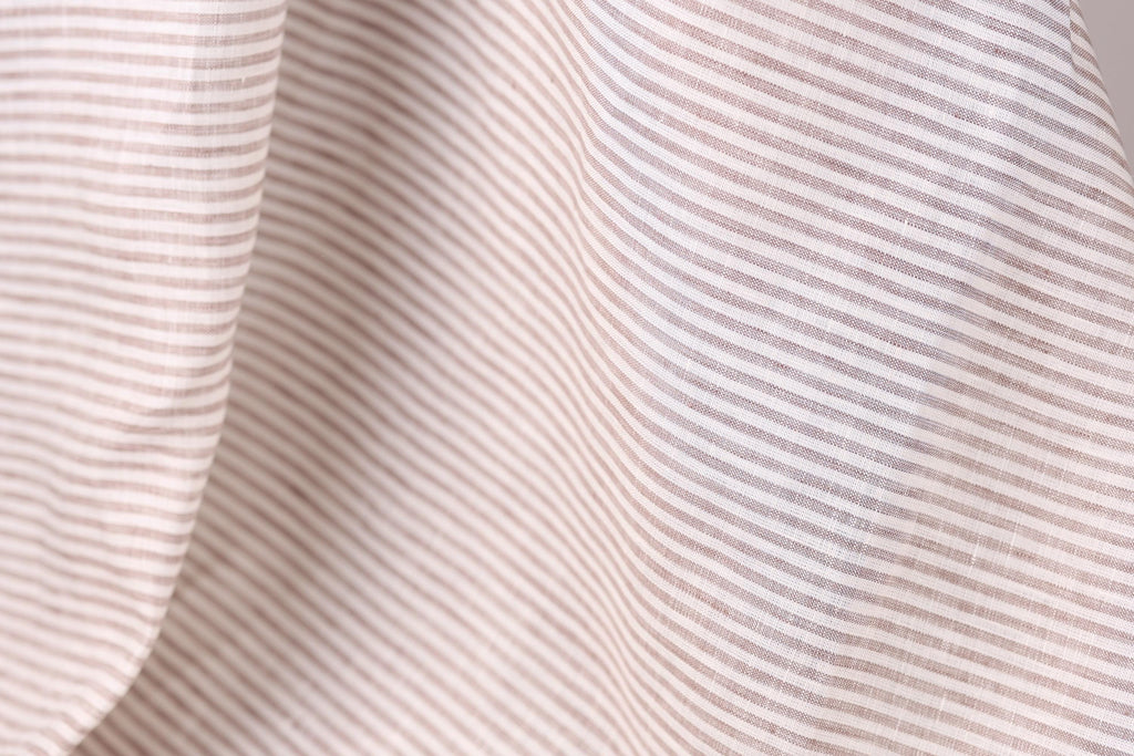 A close-up view of a fabric with horizontal stripes in various shades of brown and beige.
