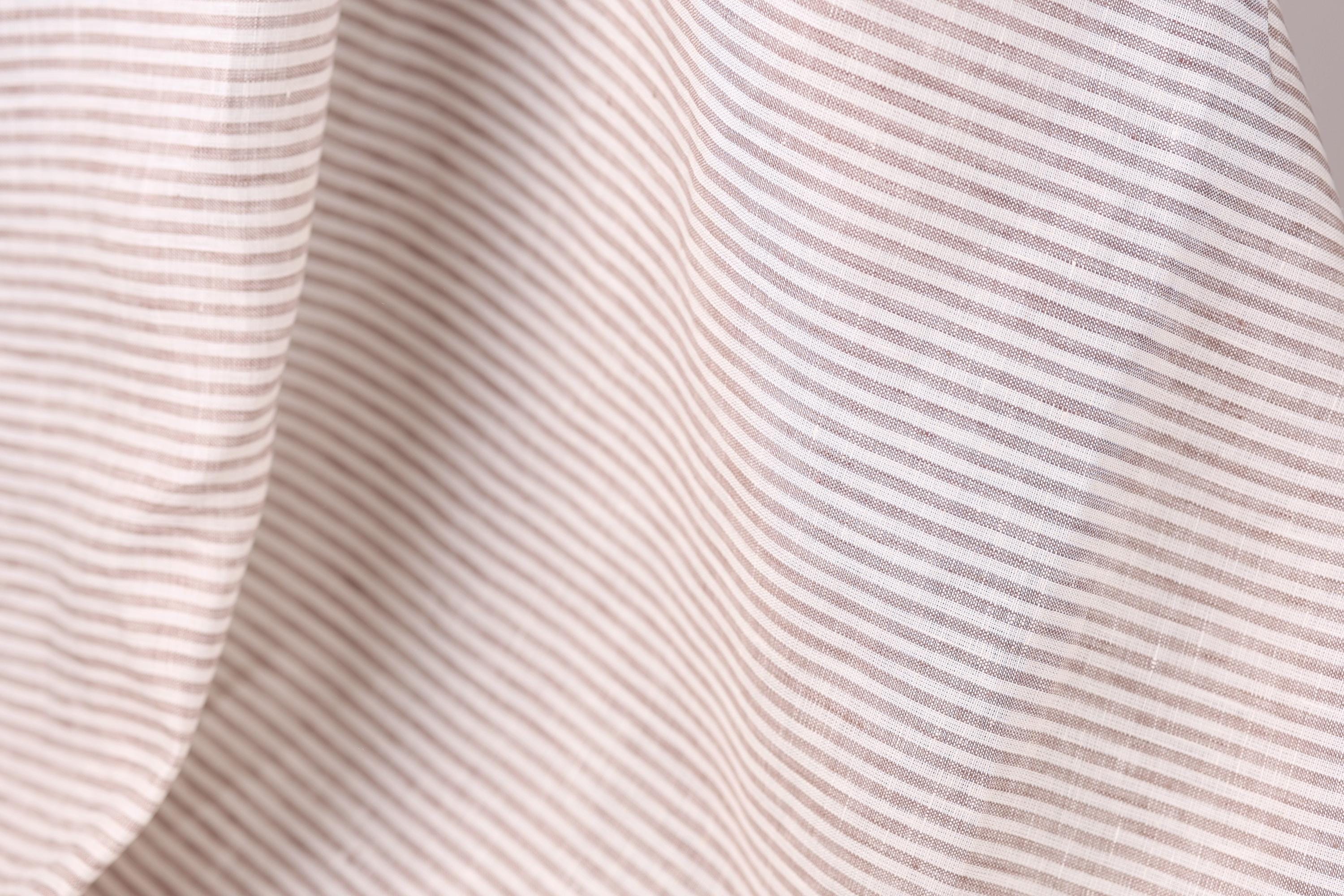 A close-up view of a fabric with horizontal stripes in various shades of brown and beige.