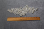 a ruler is next to a piece of silver sequins