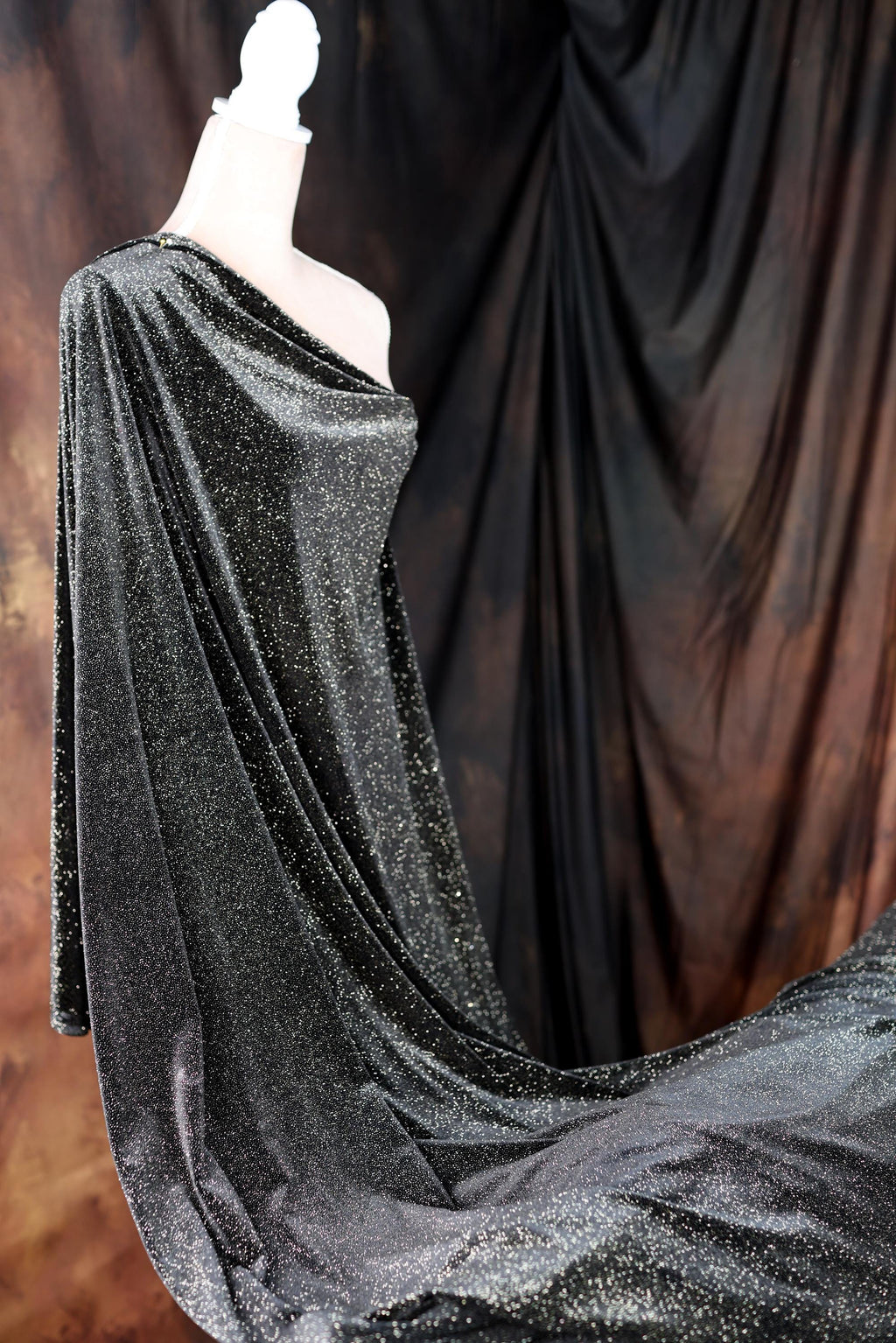 a mannequin dressed in a black and silver dress