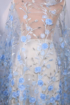 a sheer fabric with a floral pattern of blue flowers and leaves. The fabric appears to be a sheer white dress or skirt, with the blue flowers and leaves covering the entire surface.