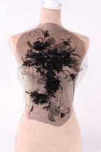 a mannequin with a decorative black lace design on its chest area.