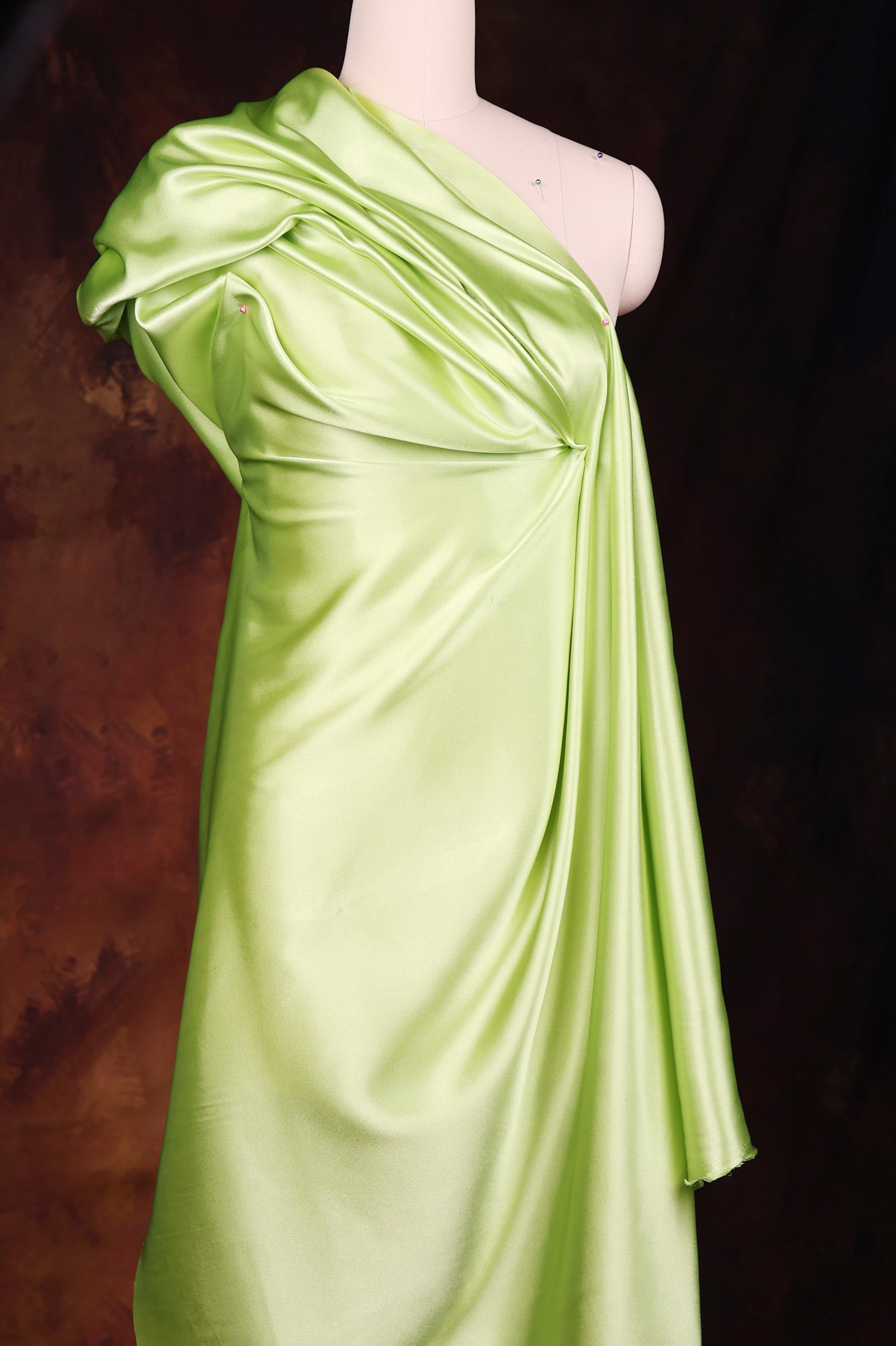 a mannequin dressed in a lime green dress