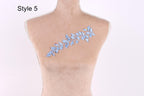 A mannequin with a decorative blue leaf pattern on its bust.