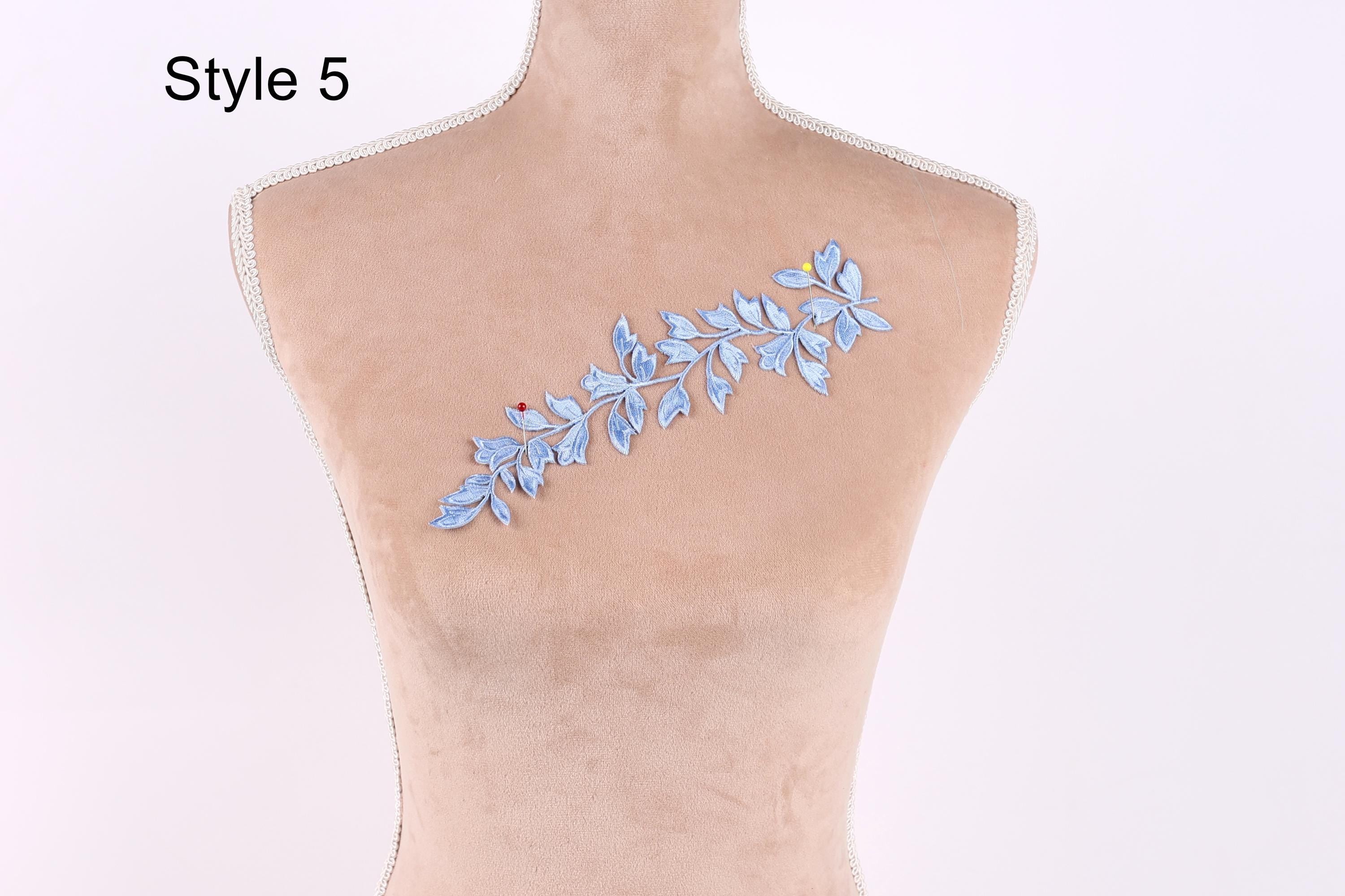 A mannequin with a decorative blue leaf pattern on its bust.