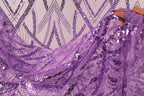 a close-up view of a piece of fabric with a purple sequin pattern. The fabric appears to be made of sheer material, and the sequins are arranged in a repeating pattern, creating a visually striking and intricate design.