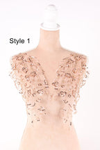 A mannequin wearing a dress with a floral pattern and sequin embellishments on the shoulders and chest area.