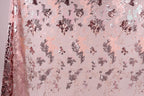 a pink and purple floral pattern with sequin accents, creating a visually appealing and textured design.
