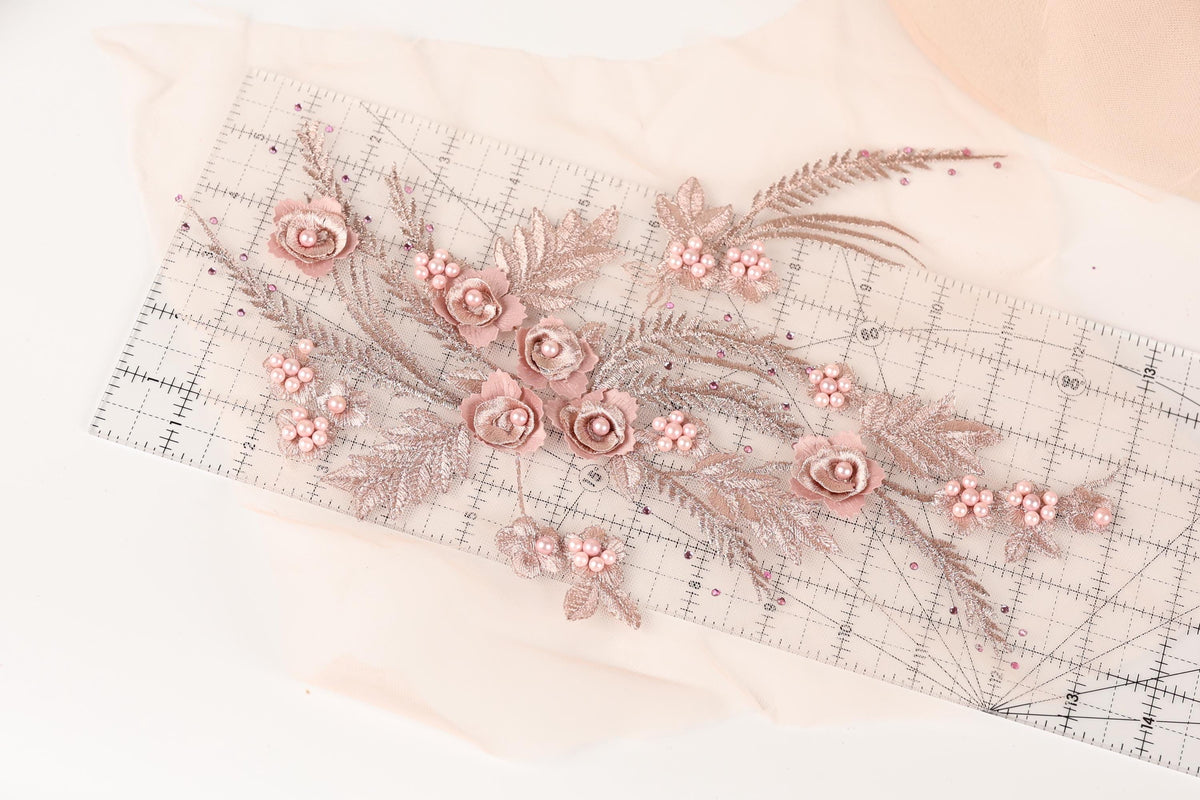 a decorative arrangement of pink flowers and leaves on a transparent ruler, creating a visually appealing and intricate design.