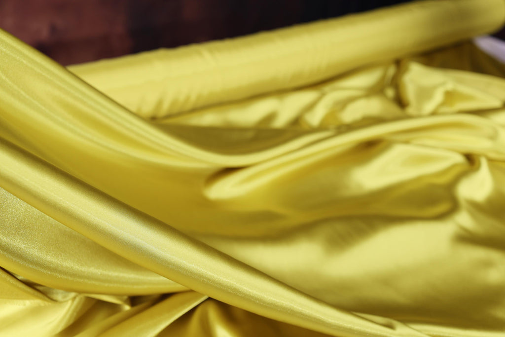 a close up of a yellow satin material