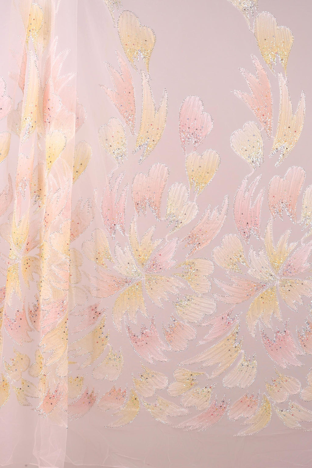 a pattern of pink and yellow flowers on a light pink background.