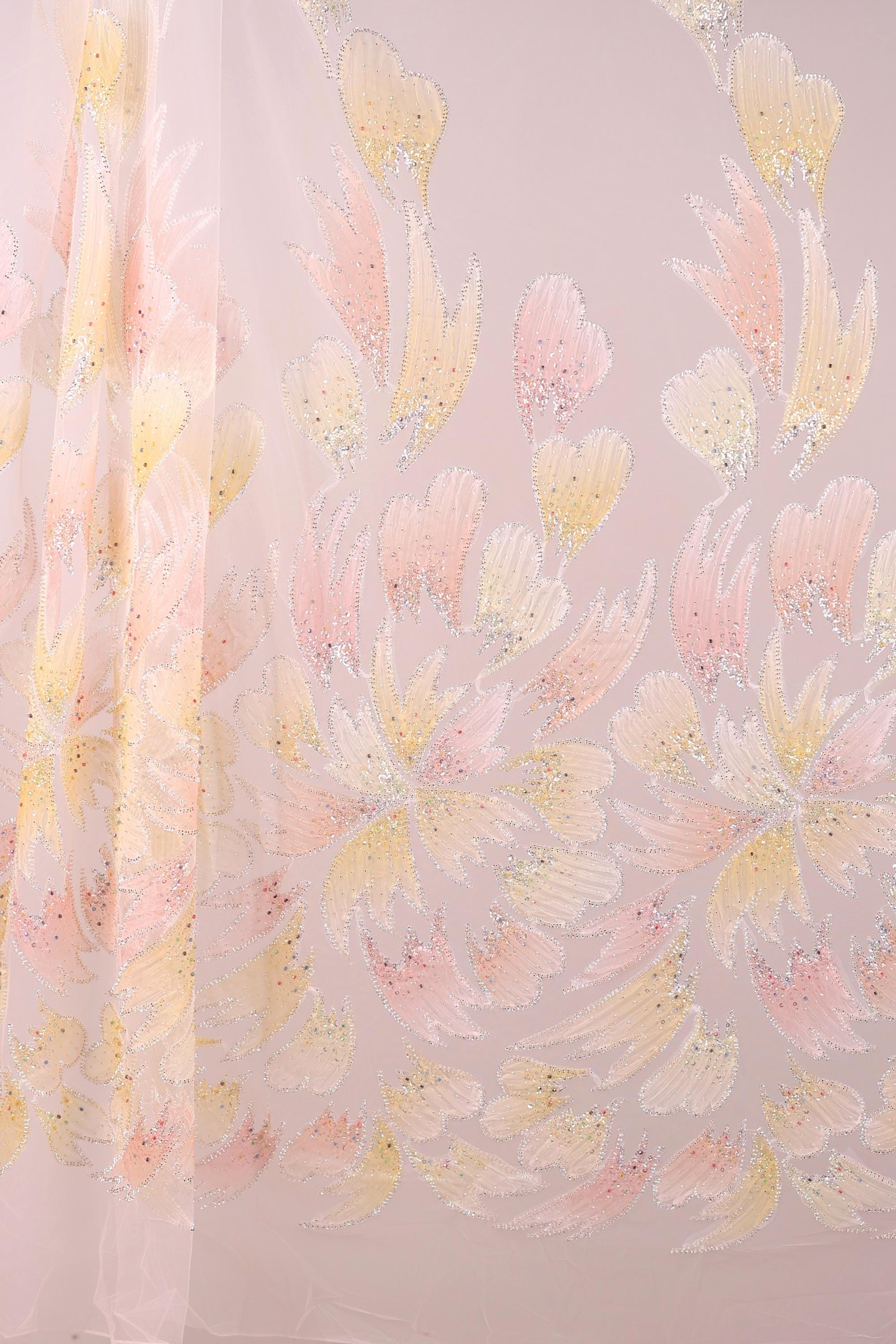 a pattern of pink and yellow flowers on a light pink background.