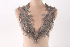 A mannequin wearing a silver sequin and lace neckline.