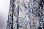 a close-up view of a fabric with a pattern of blue and silver sequins, creating a visually striking and intricate design.