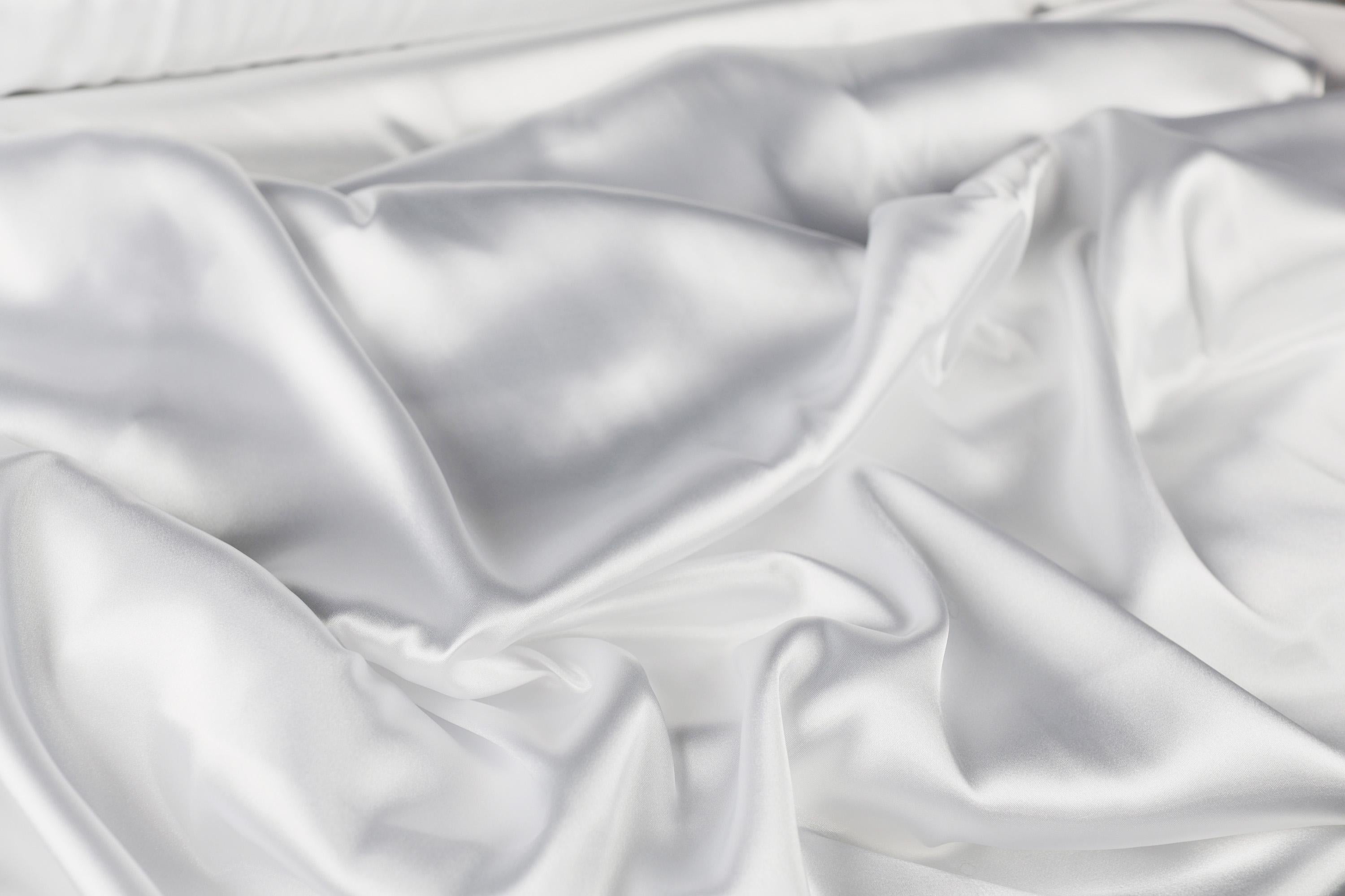 a close up of a white satin material