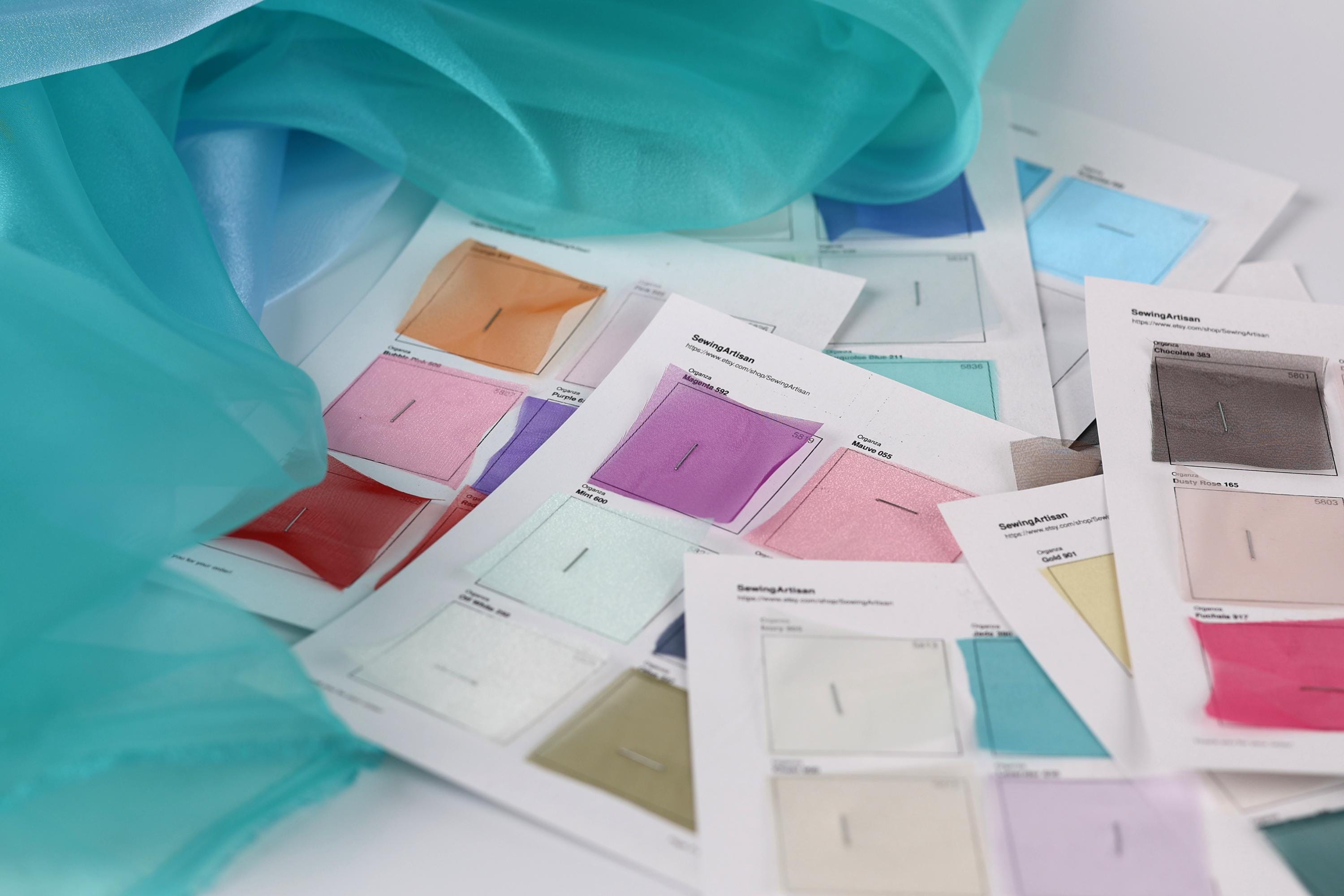 a collection of fabric swatches or color samples, each with a corresponding color label, likely used for design or fashion purposes.