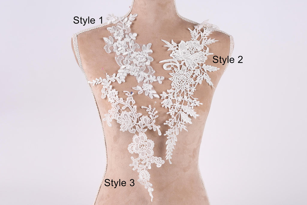 A mannequin with a white lace bodice and three different styles of lace appliques displayed on it.