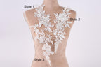 A mannequin with a white lace bodice and three different styles of lace appliques displayed on it.