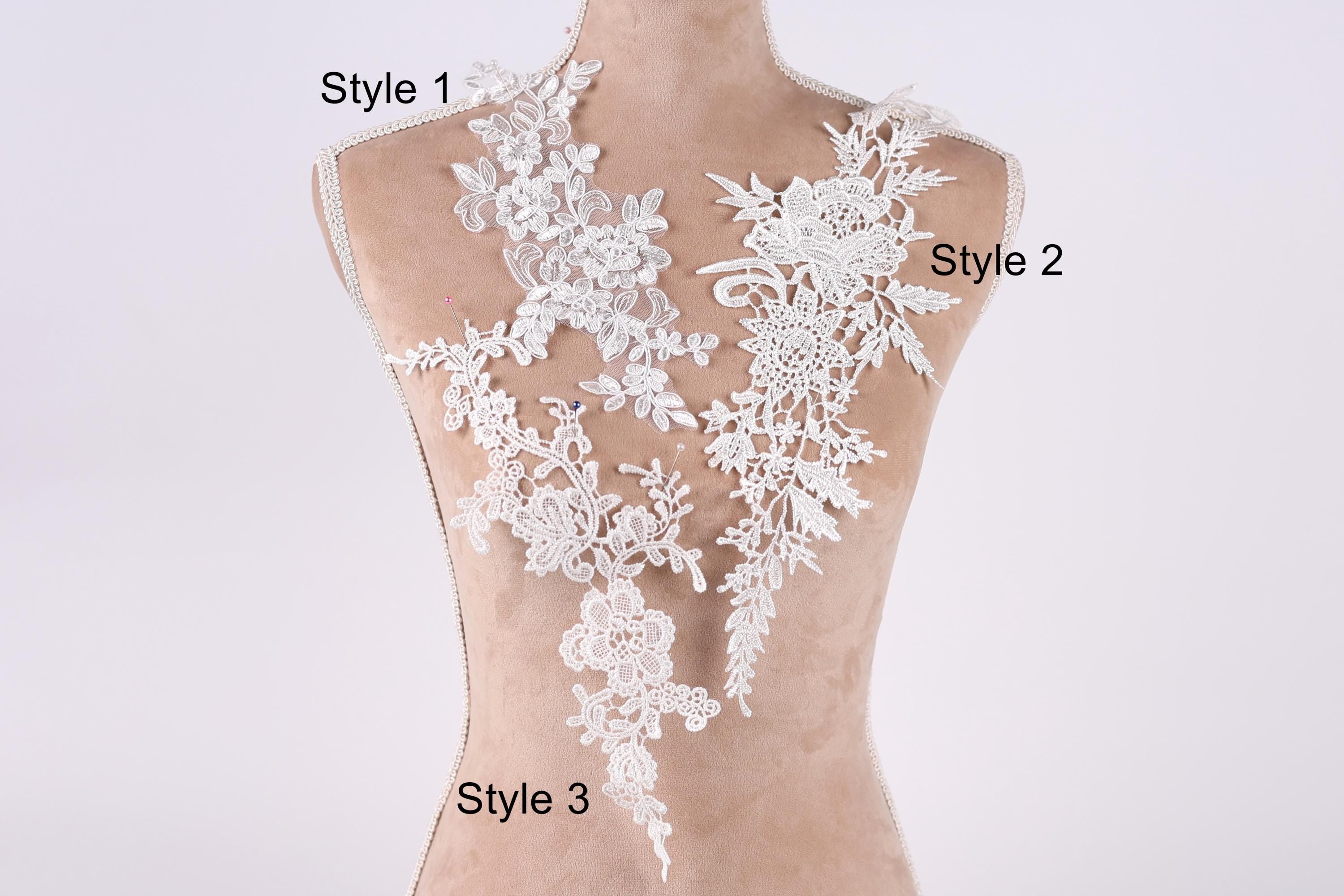 A mannequin with a white lace bodice and three different styles of lace appliques displayed on it.