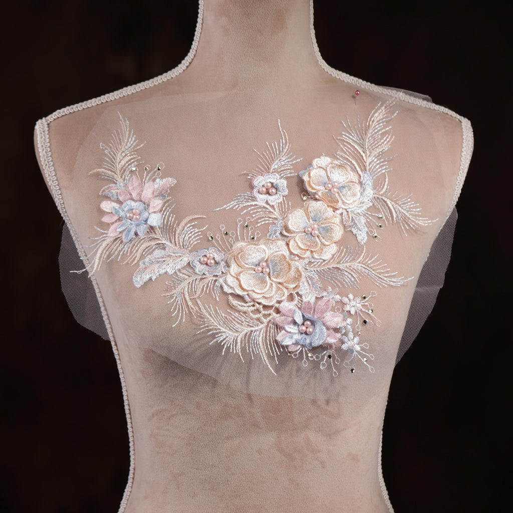 A mannequin with a delicate floral embroidered on its chest.