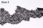 A close-up view of a delicate black lace fabric with intricate floral patterns and textures.