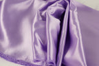 a close-up view of a soft, shiny purple satin fabric.