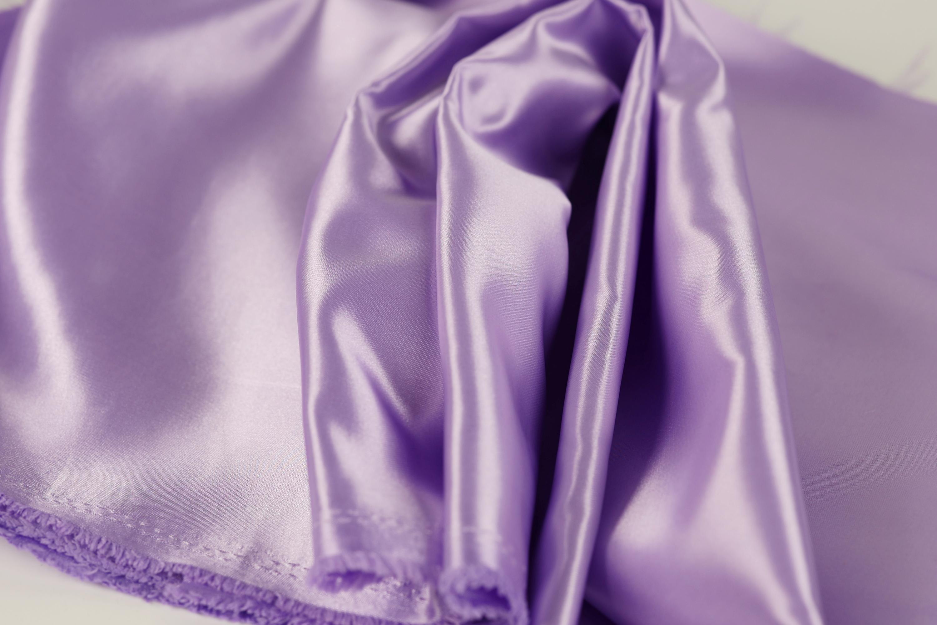 a close-up view of a soft, shiny purple satin fabric.