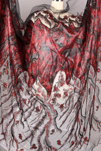 a fabric with a striking red and black pattern, including a mix of floral and abstract designs. The fabric appears to be a sheer material, with a black and white color scheme. The overall composition of the image is visually captivating and intricate.