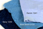 three fabric swatches, each with a different color and texture. The topmost fabric is navy blue, the middle one is a light blue with sparkles, and the bottom one is a light purple. The text labels the fabric swatches as Navy 1245, Blue Storm 0122, and Denim 1241.