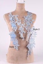 A mannequin wearing a dress with various blue lace patterns, each labeled with a different style number.