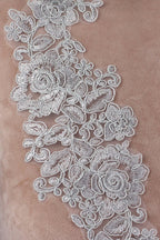 a close-up view of a delicate, intricate white lace pattern with floral designs.
