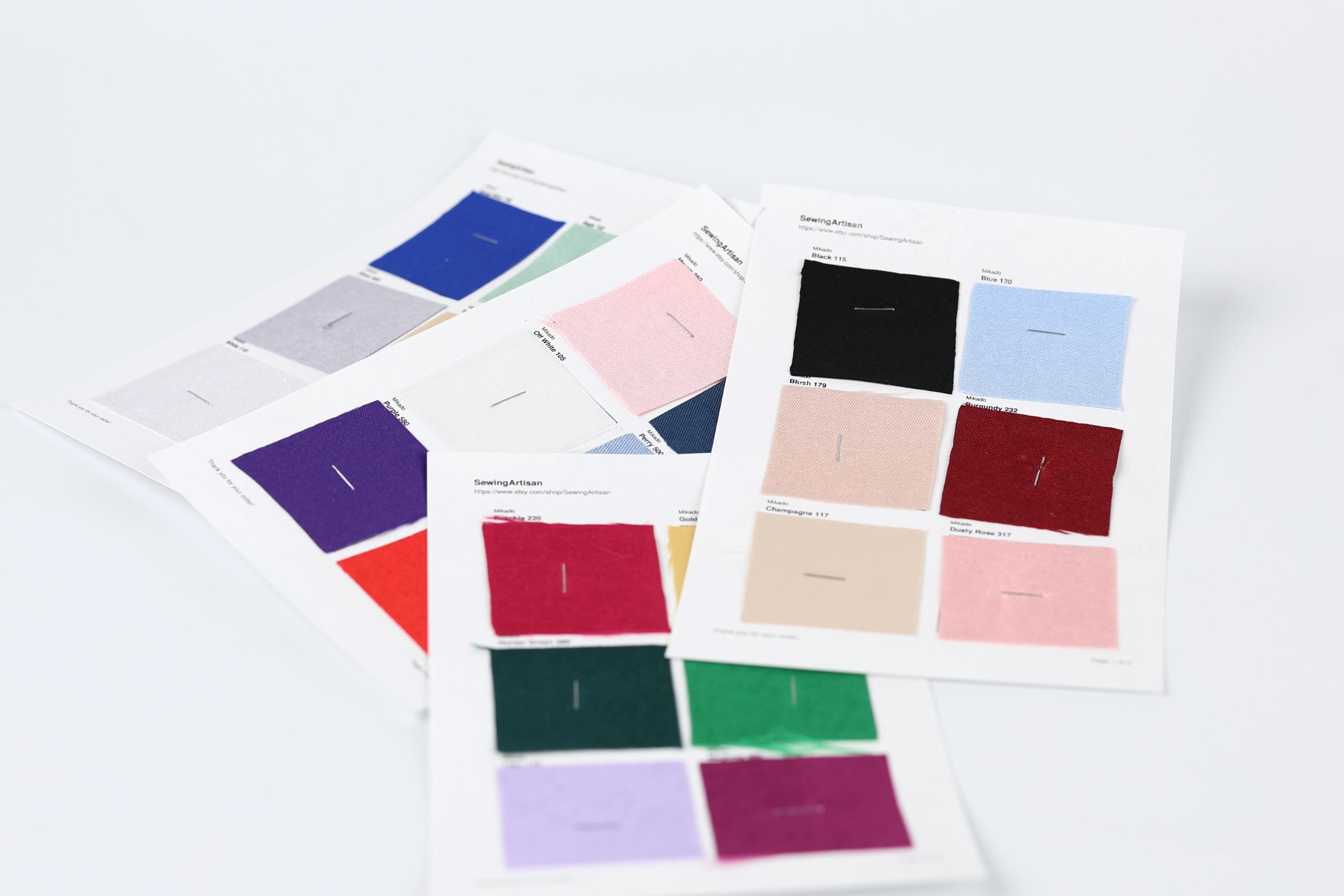several fabric swatches with different colors and patterns, arranged on a white background.