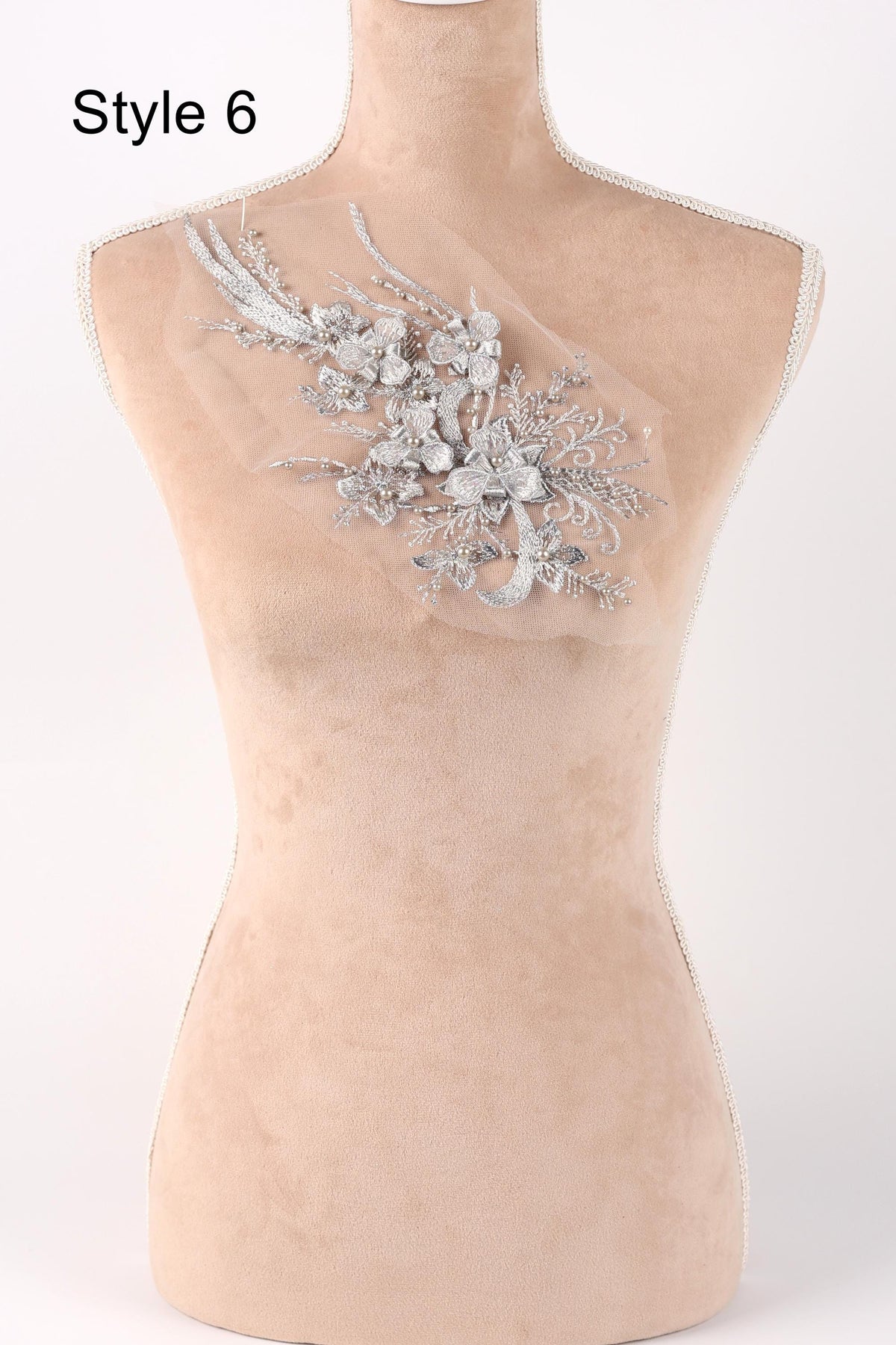 A mannequin with a decorative floral embroidery on its bust.
