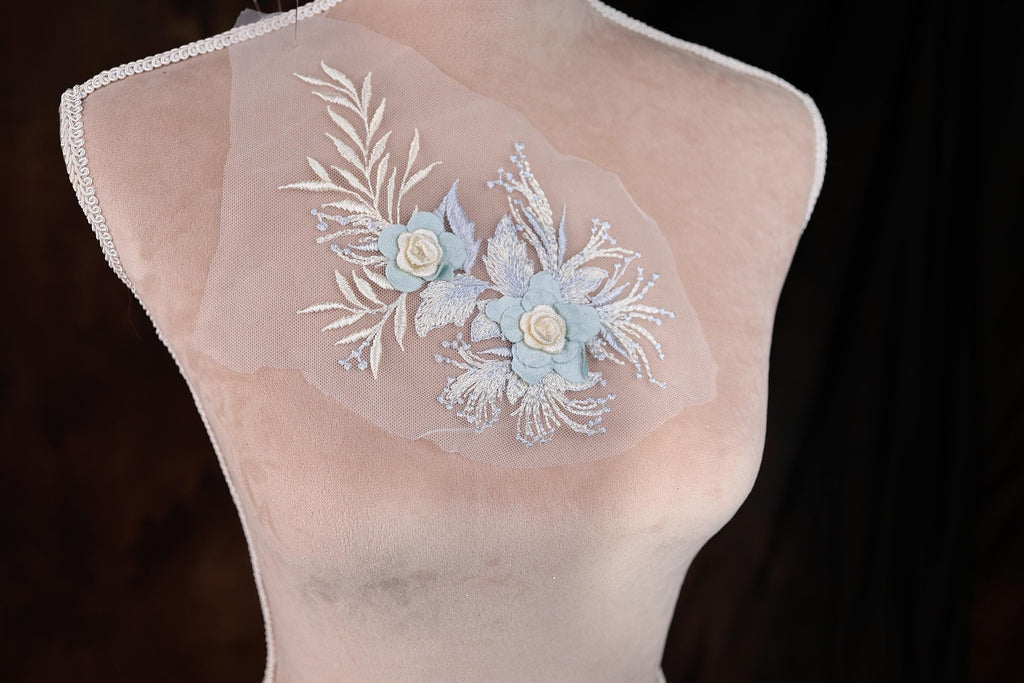 A mannequin with a delicate floral embroidered on its chest.