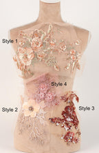 A mannequin with various decorative floral and sequin embellishments on its bust and hips, showcasing different styles and designs.