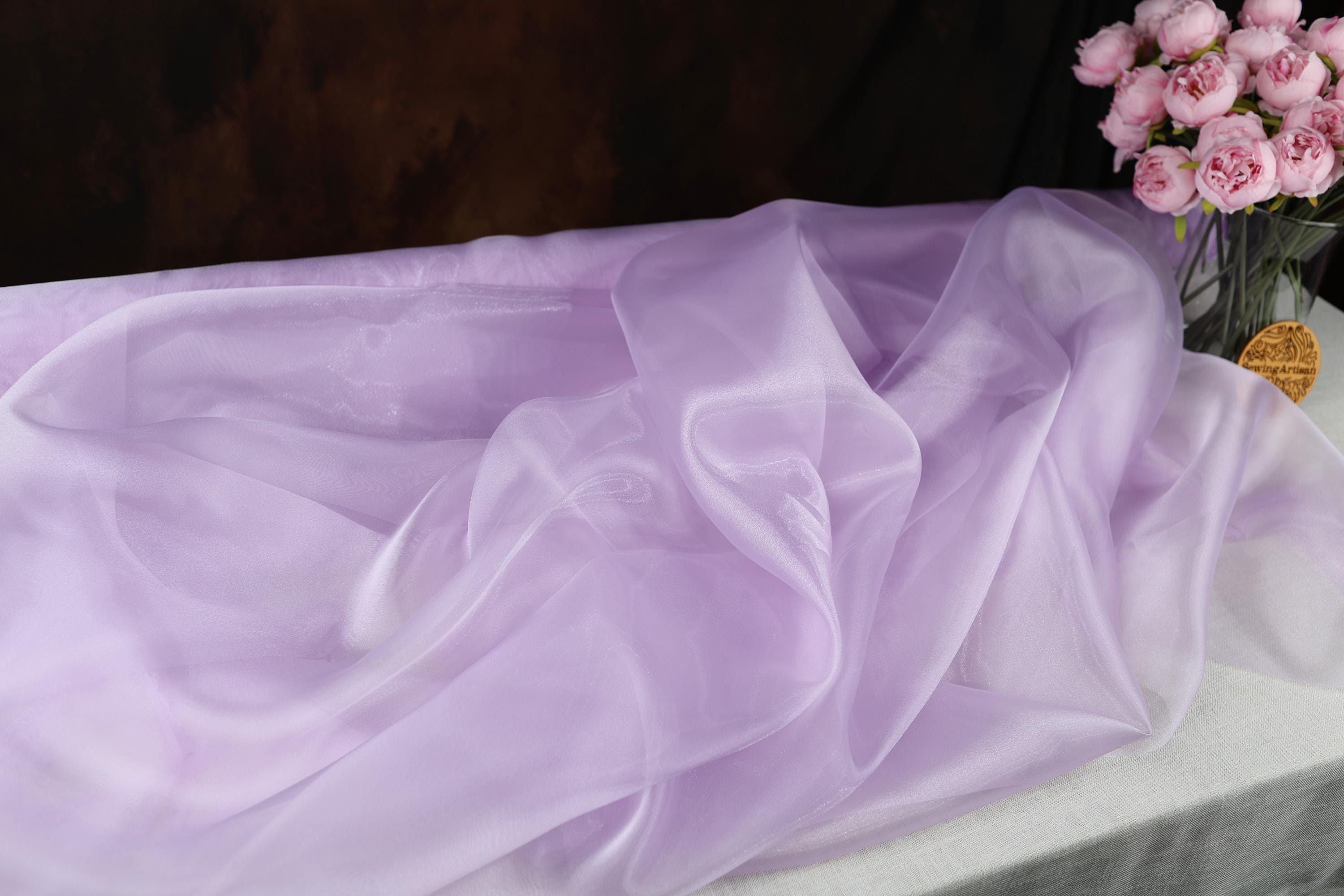 a vase filled with pink flowers on top of a table