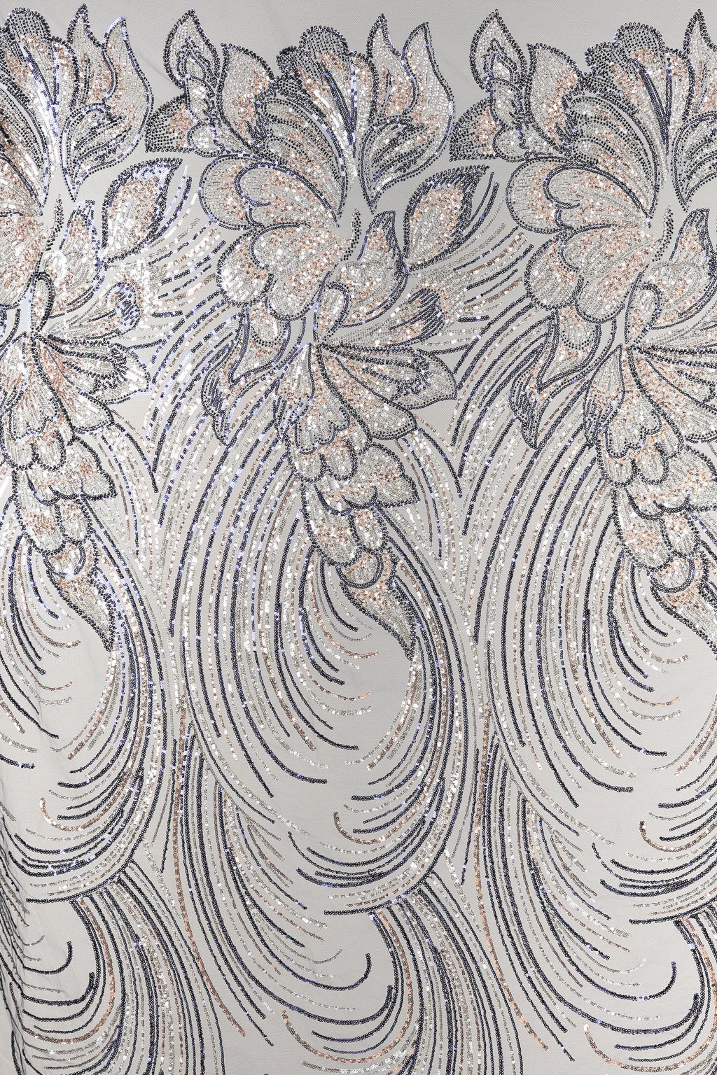 a close-up view of a fabric with a repeating pattern of intricate floral designs in shades of gray and white, accented with gold glitter. The pattern is composed of curved lines and swirls, creating a sense of movement and elegance. The fabric appears to be a type of sheer material, suitable for various applications such as clothing or home decor.