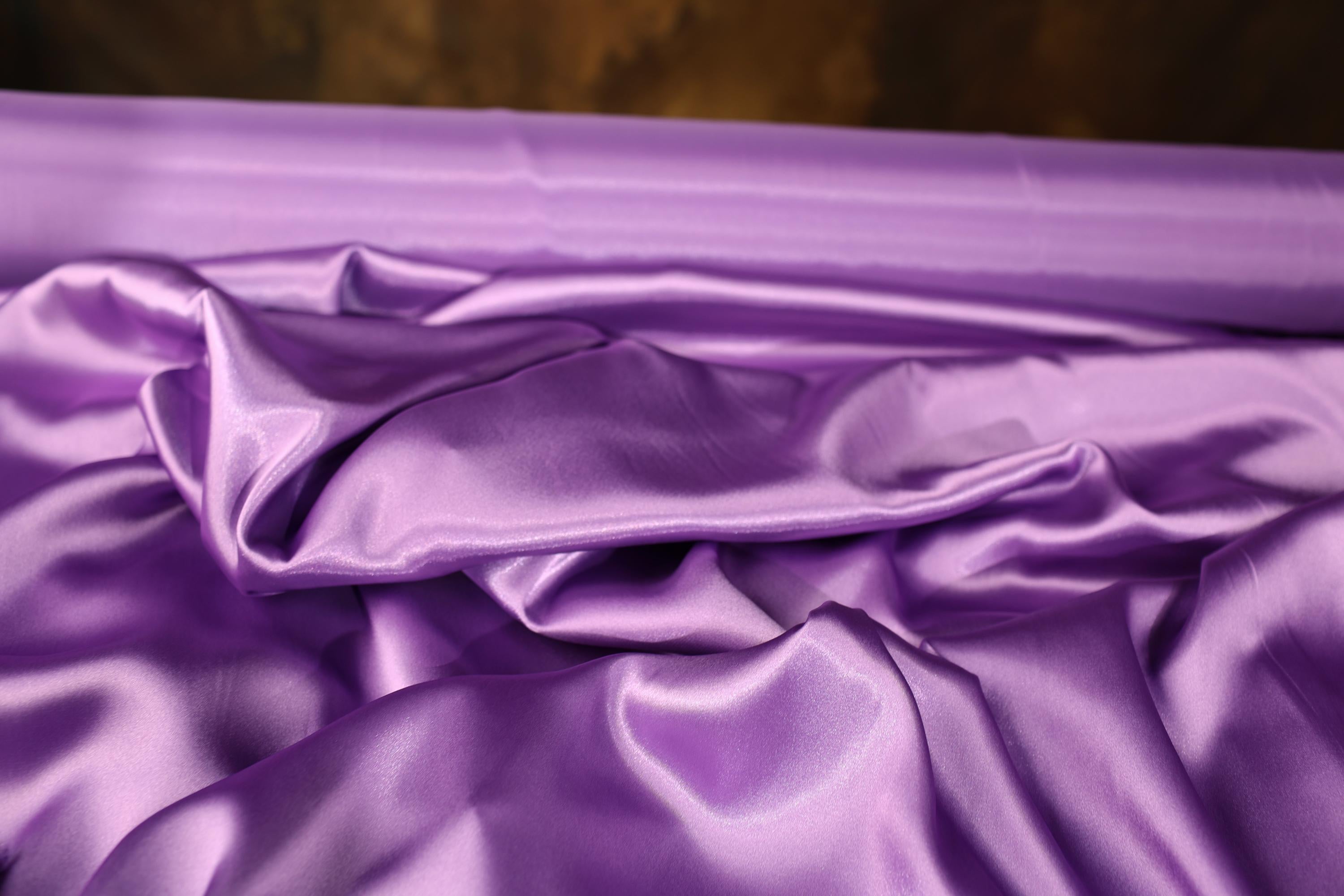 a close up of a purple satin material
