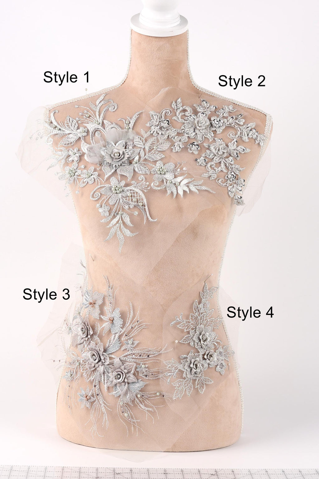 A mannequin with various decorative lace and floral embellishments on its bust area, each labeled with a different style number.